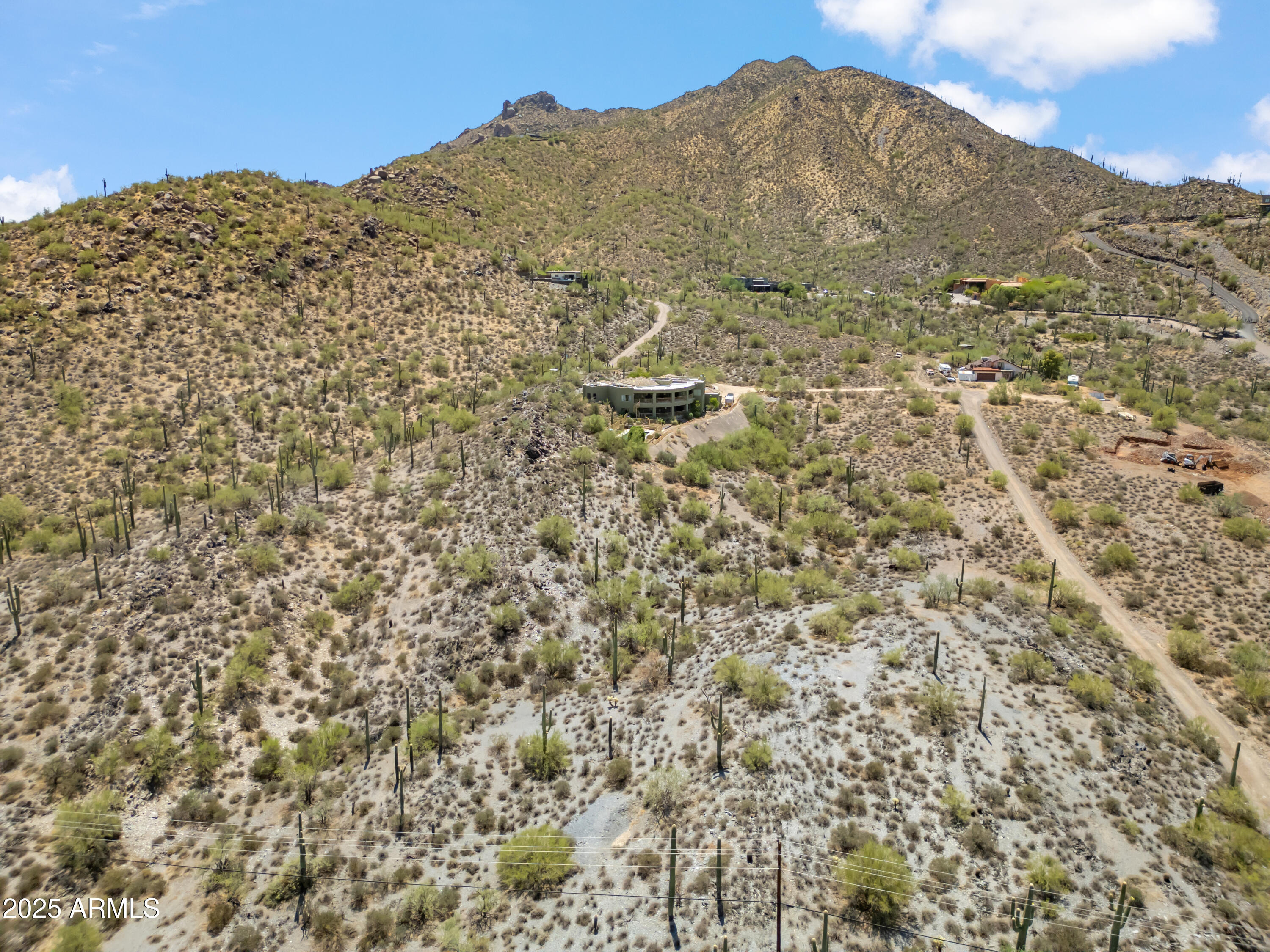 a view of a large building with mountains in the background