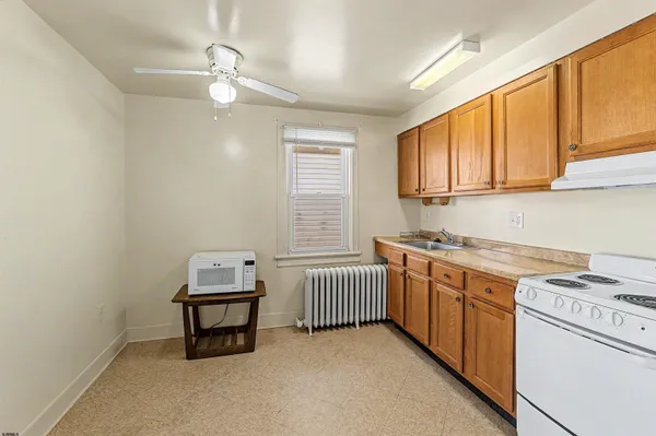 a kitchen with sink cabinets and window
