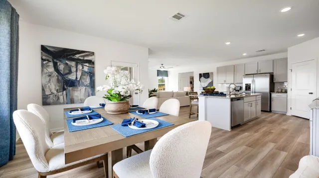 a living room with furniture a flat screen tv and a potted plant