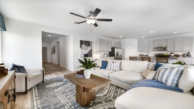 a living room with furniture and a wall painting