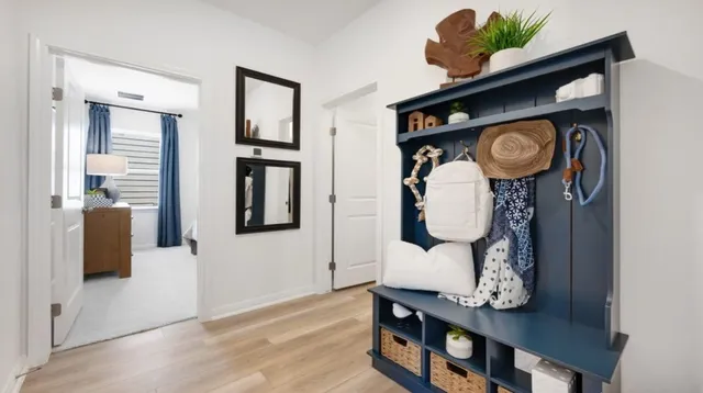 a bedroom with a bed and a lamp on dresser