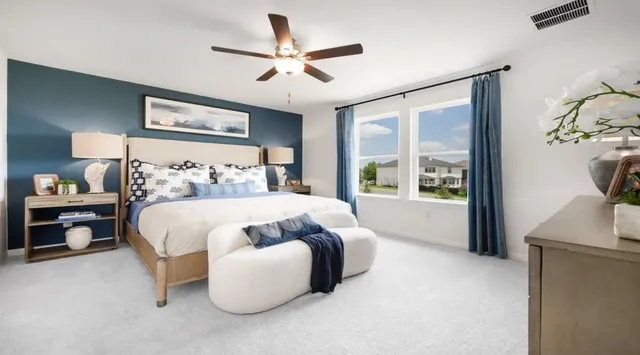 a kitchen with stainless steel appliances a dining table chairs and a refrigerator
