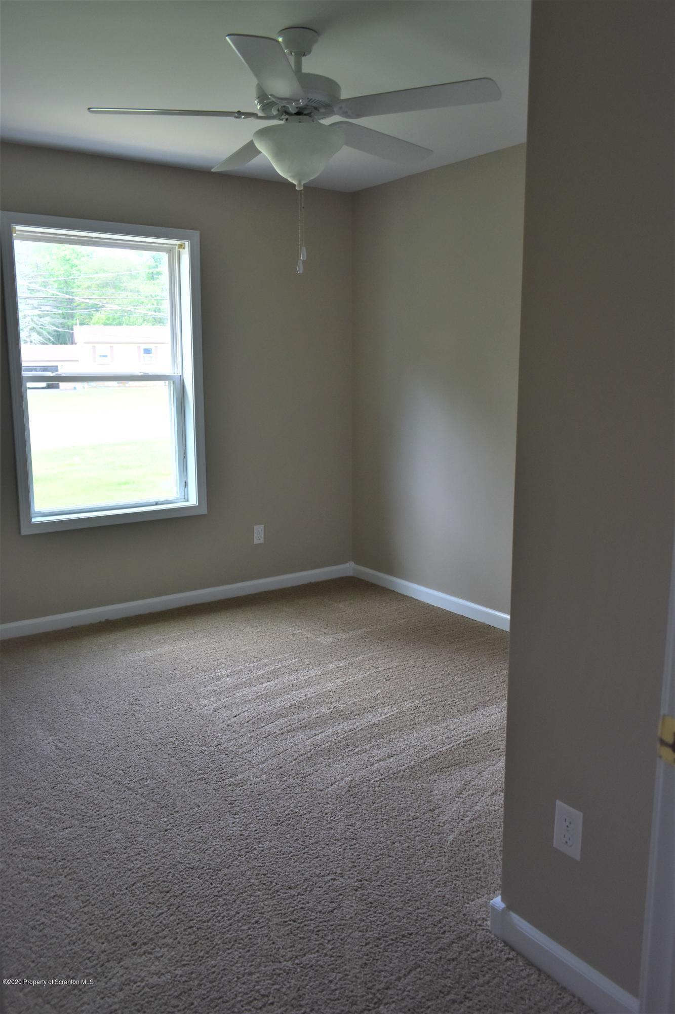 1597 Mt Cobb Road Lake Ariel, PA 18436 - Photo 11 of 28 an empty room with a window and a fan