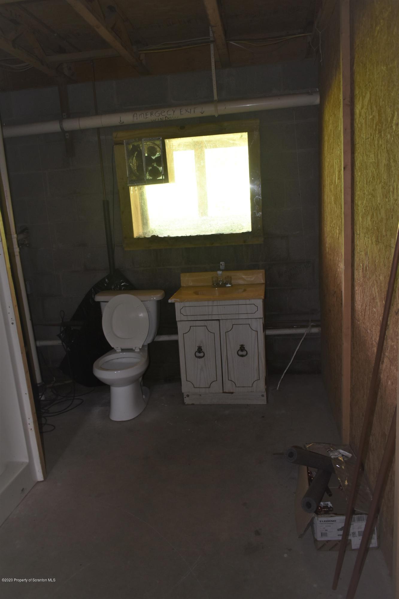 1597 Mt Cobb Road Lake Ariel, PA 18436 - Photo 16 of 28 a bathroom with a toilet sink and mirror