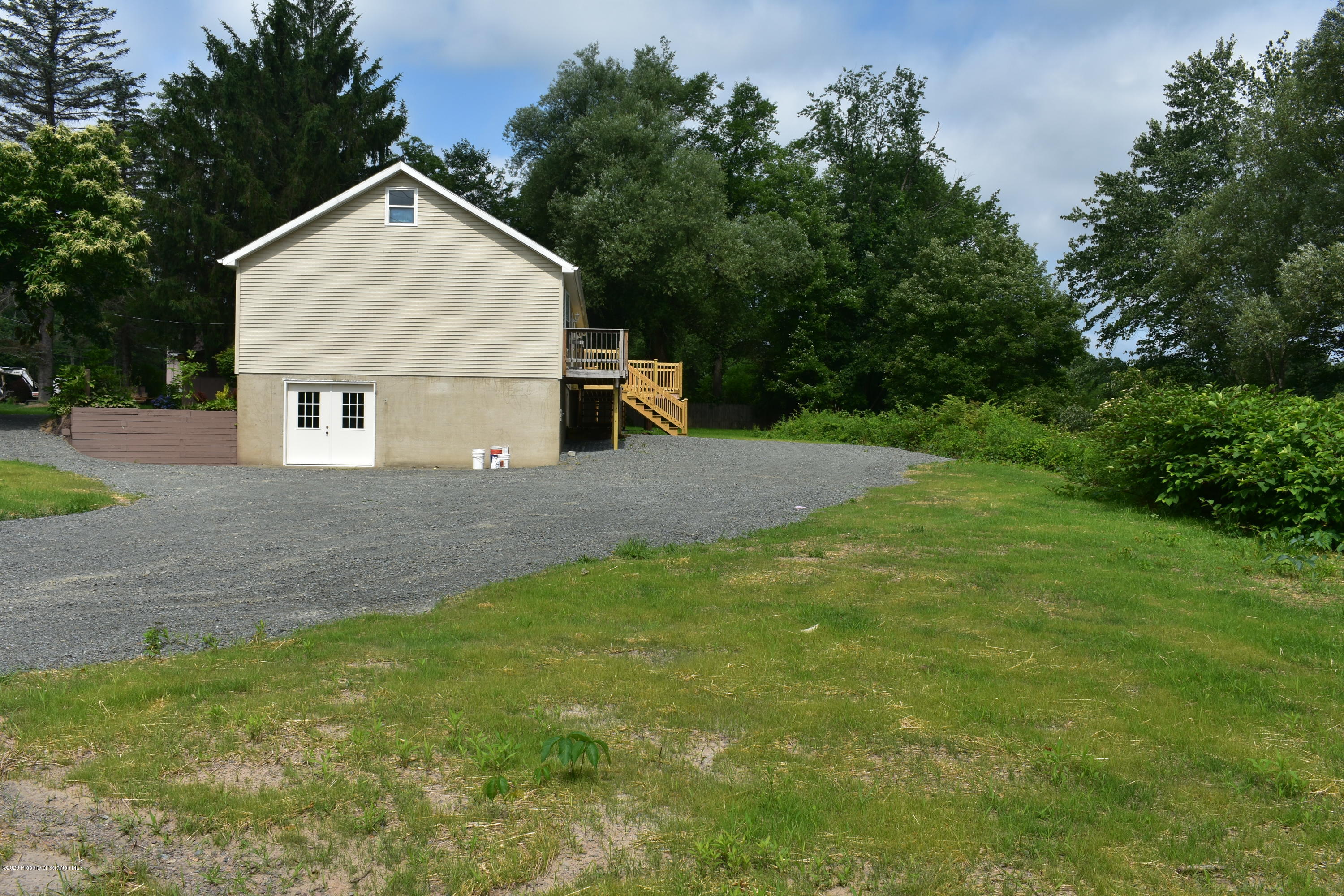 1597 Mt Cobb Road Lake Ariel, PA 18436 - Photo 20 of 28 a house with green field in front of it