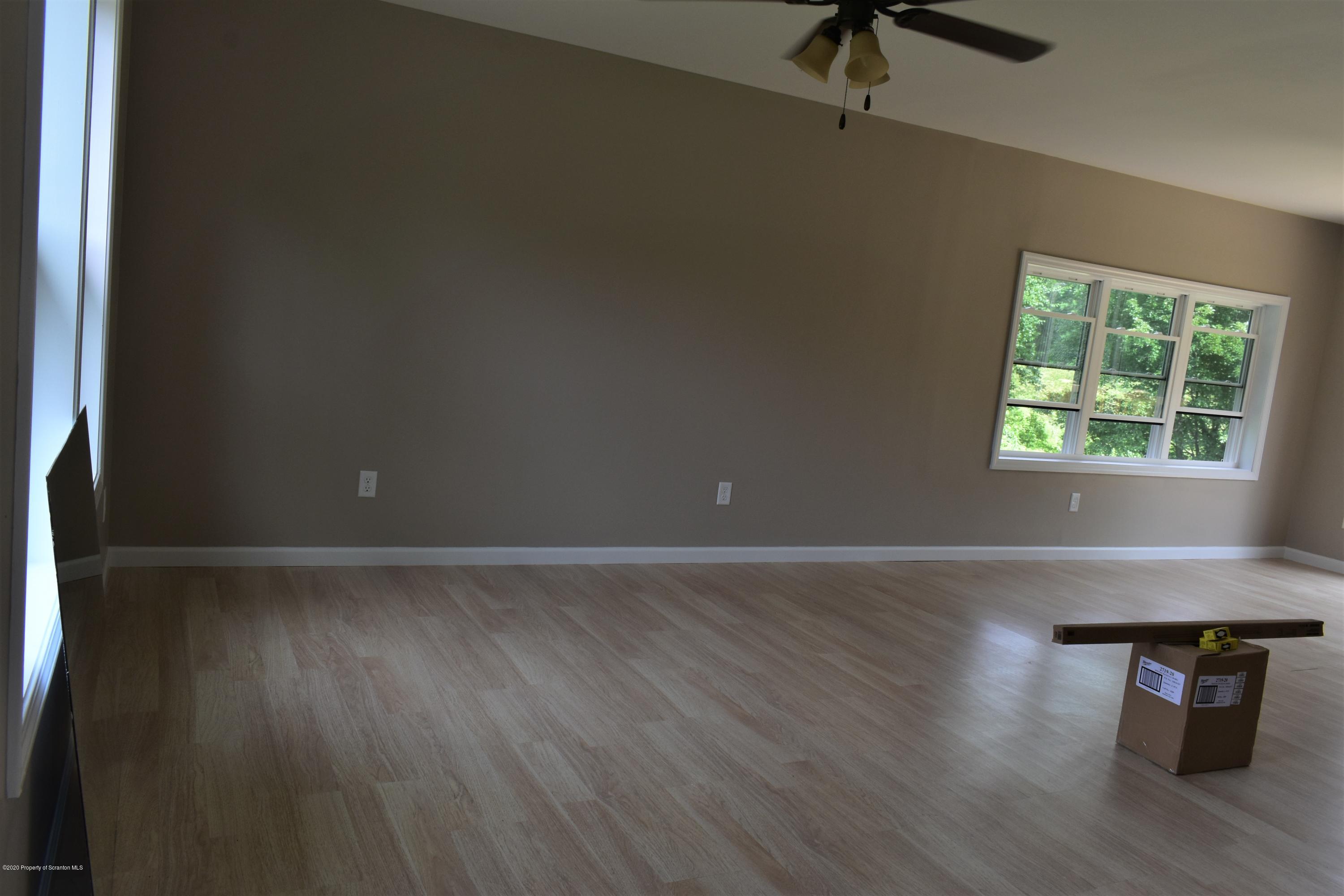 1597 Mt Cobb Road Lake Ariel, PA 18436 - Photo 2 of 28 an empty room with wooden floor and windows