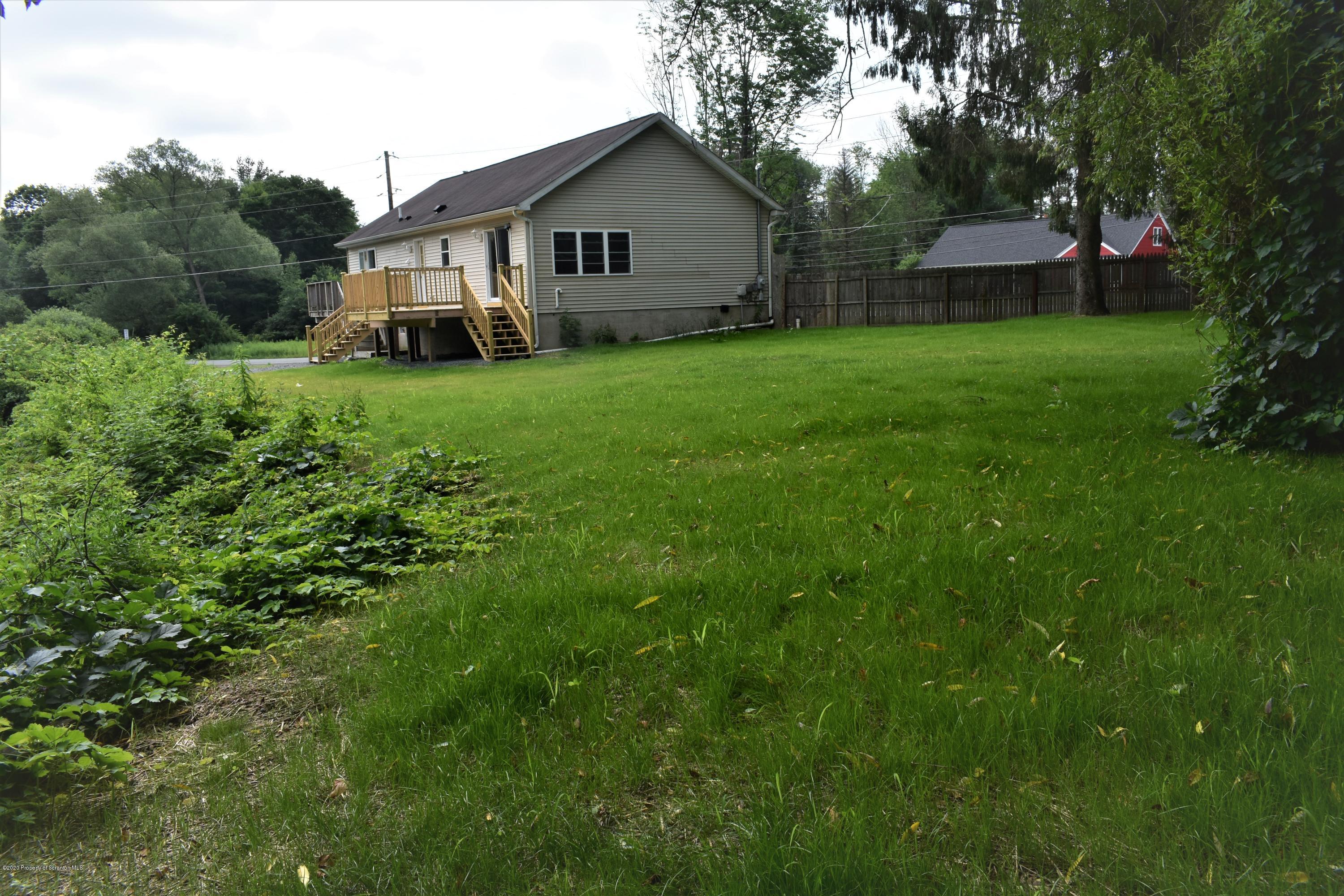 1597 Mt Cobb Road Lake Ariel, PA 18436 - Photo 25 of 28 a view of a house with a yard and sitting area