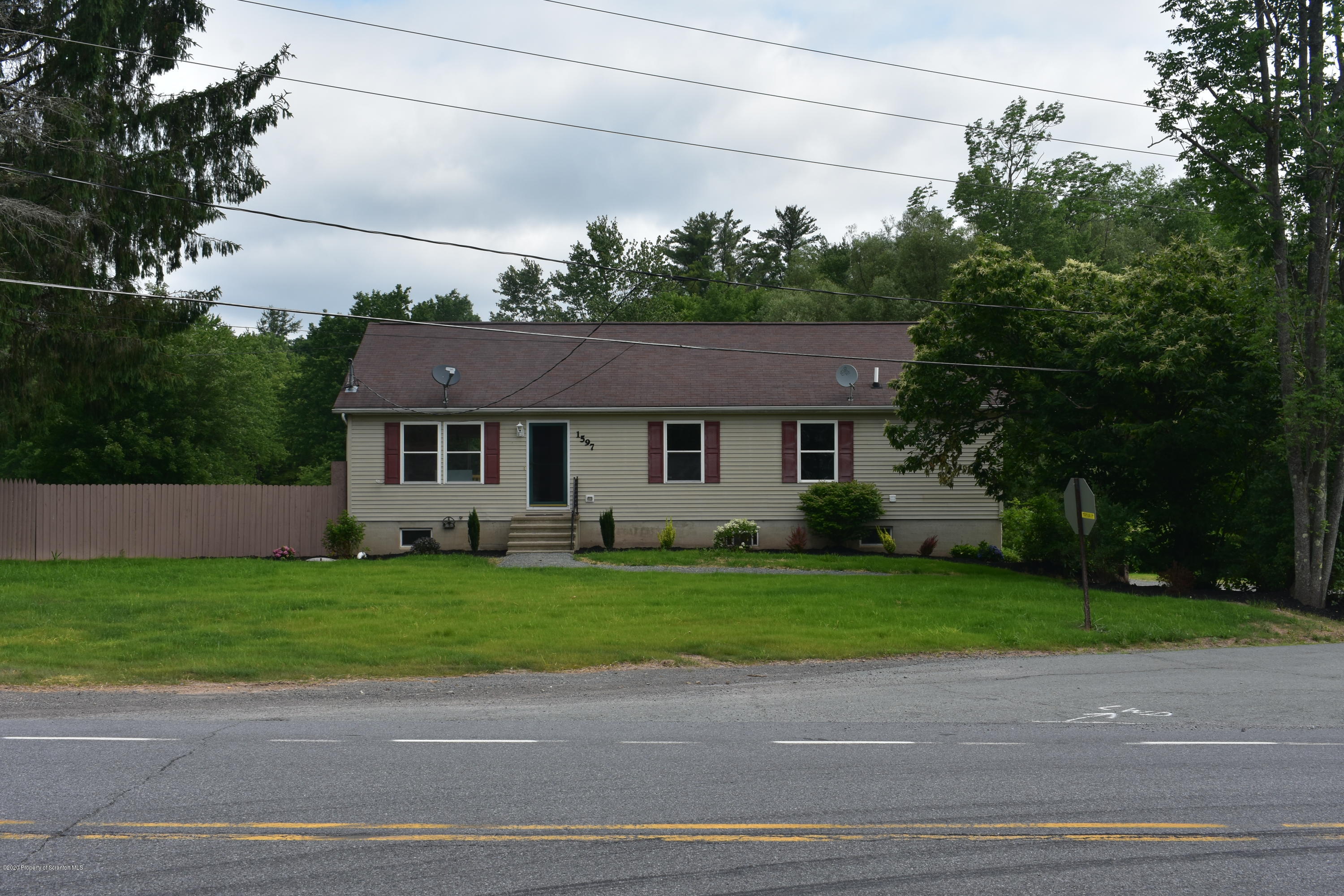 1597 Mt Cobb Road Lake Ariel, PA 18436 - Photo 28 of 28 a front view of a house with a garden