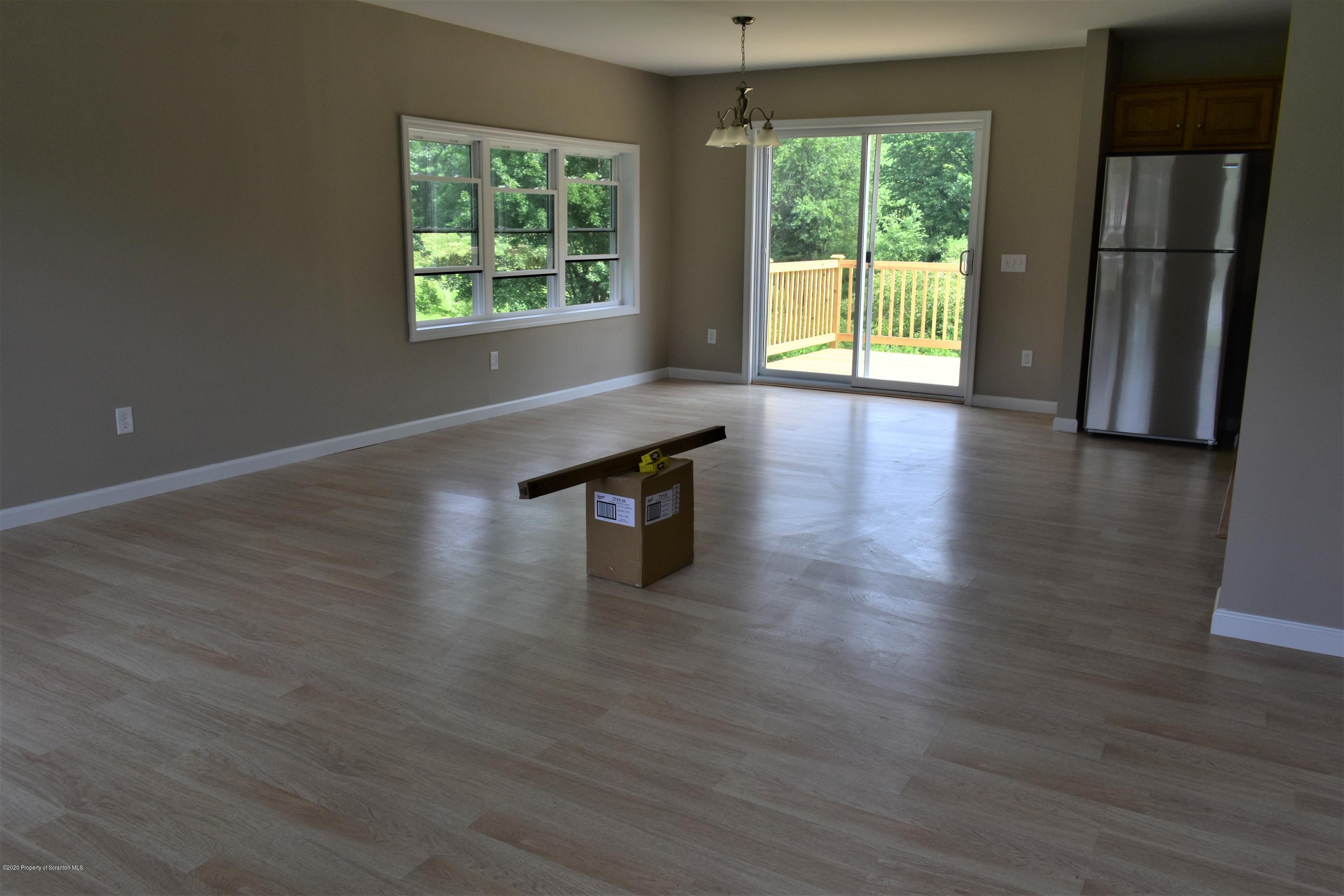 1597 Mt Cobb Road Lake Ariel, PA 18436 - Photo 3 of 28 an empty room with wooden floor and windows