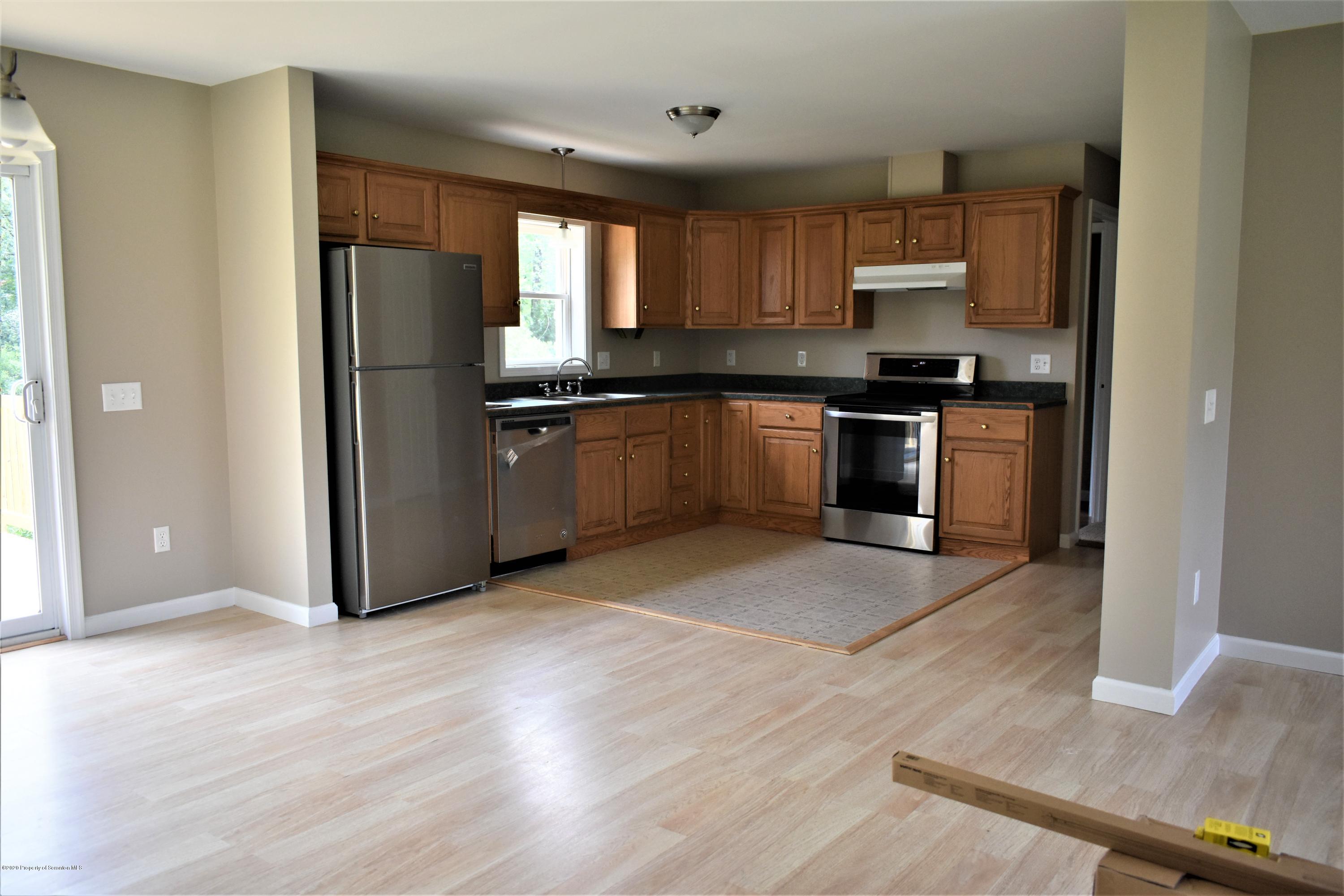 1597 Mt Cobb Road Lake Ariel, PA 18436 - Photo 6 of 28 a large kitchen with stainless steel appliances granite countertop a refrigerator and a sink