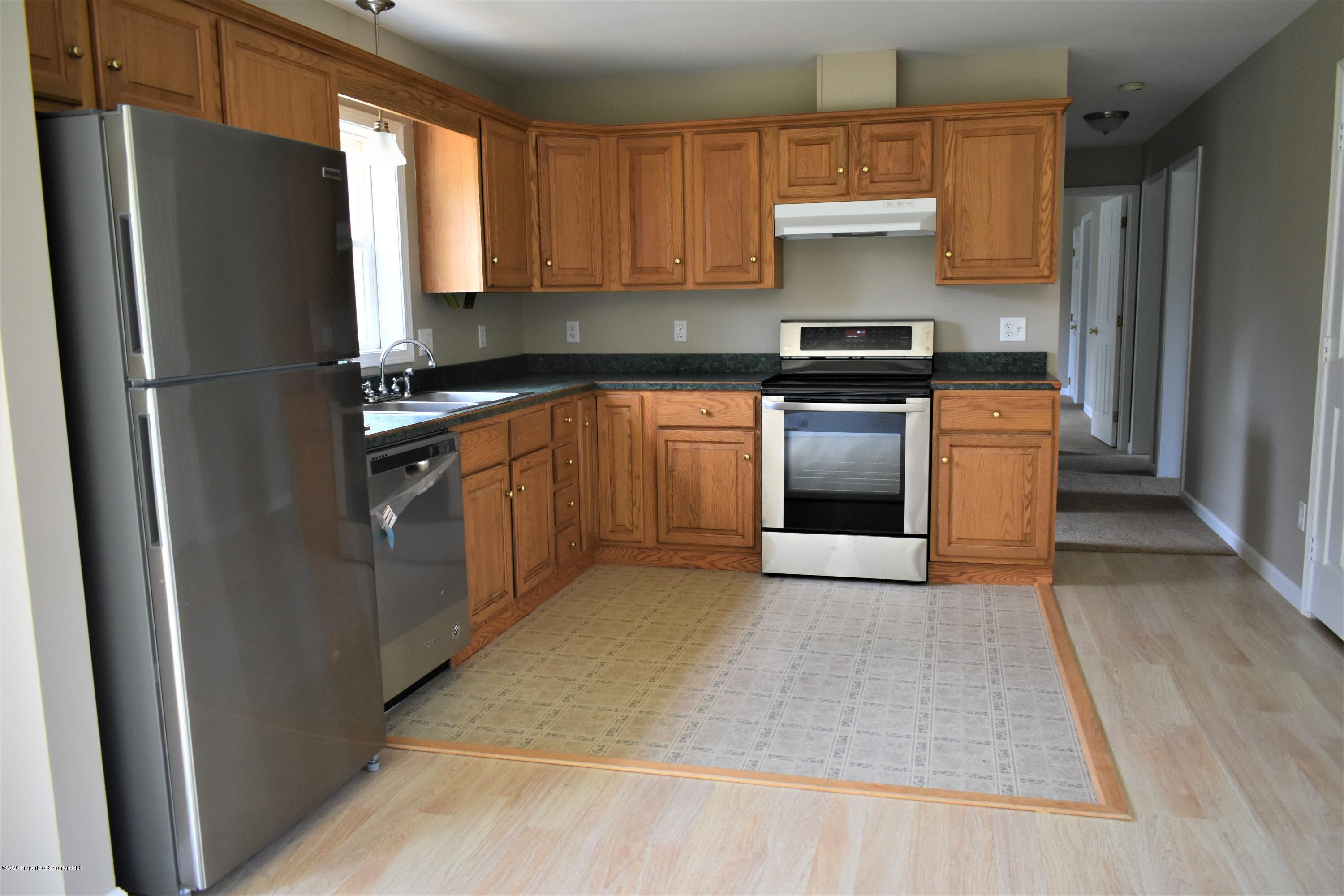 1597 Mt Cobb Road Lake Ariel, PA 18436 - Photo 7 of 28 a kitchen with stainless steel appliances granite countertop a refrigerator and a stove