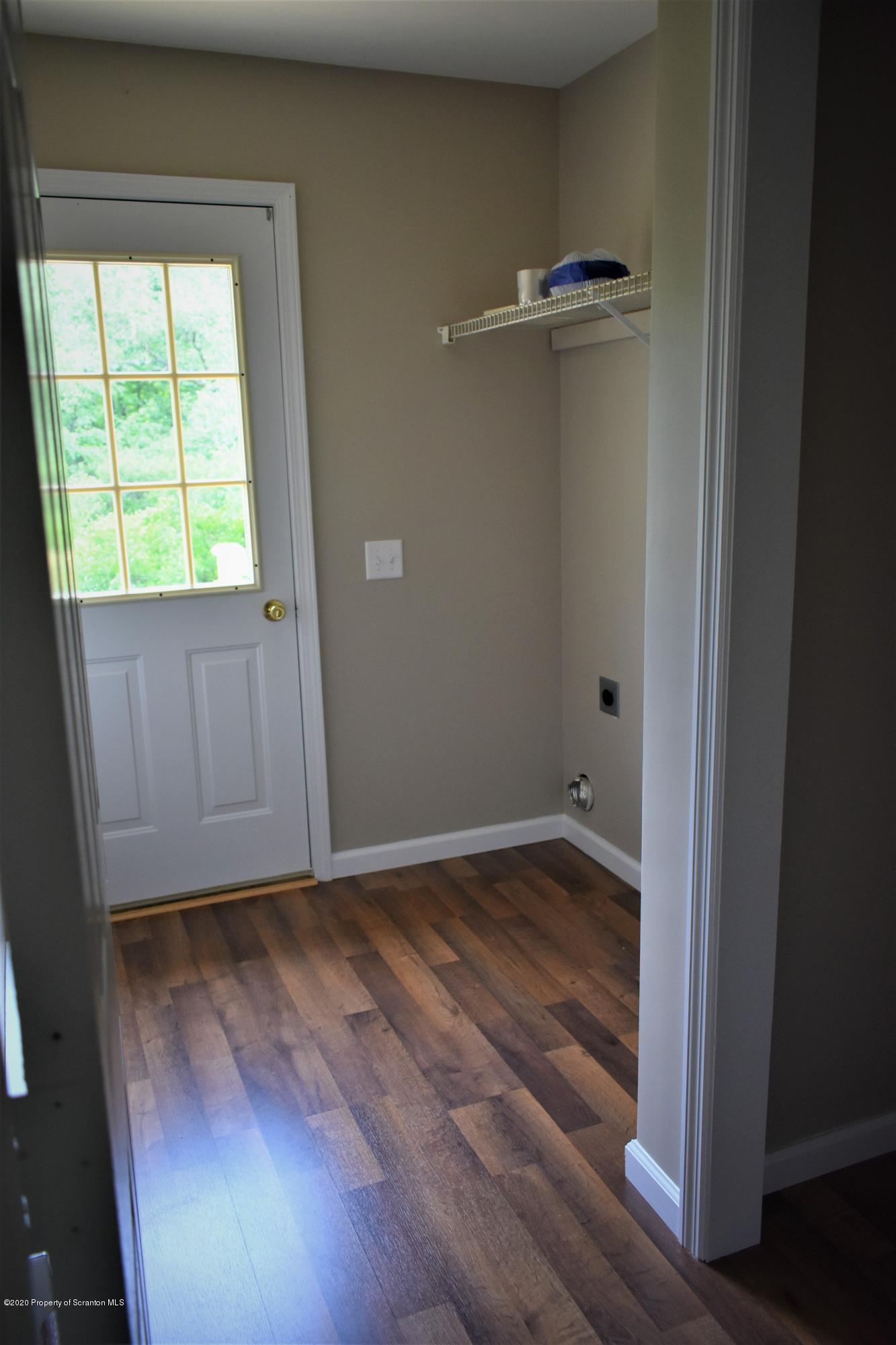 1597 Mt Cobb Road Lake Ariel, PA 18436 - Photo 8 of 28 an empty room with wooden floor and windows