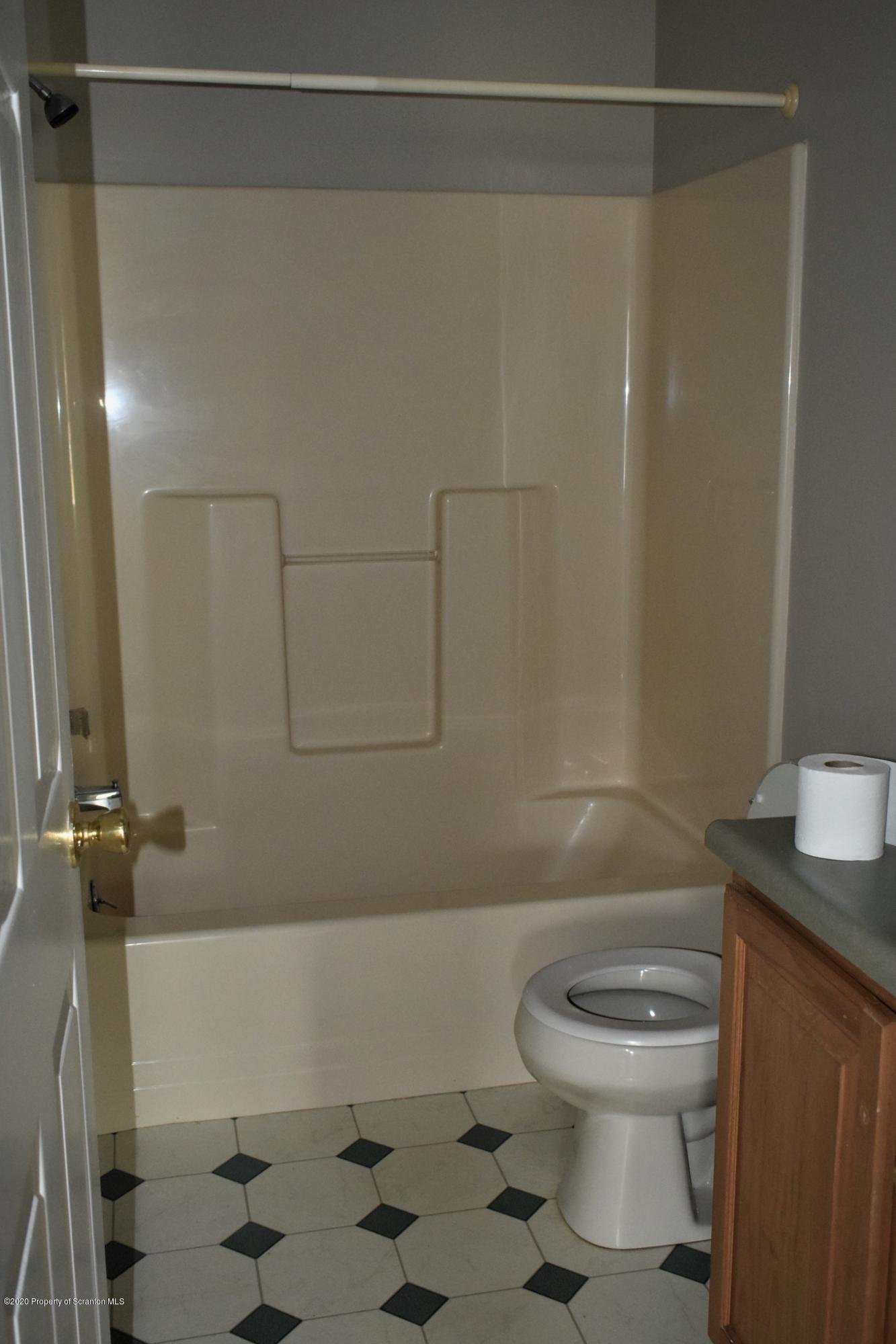 1597 Mt Cobb Road Lake Ariel, PA 18436 - Photo 9 of 28 a white toilet sitting next to a bath tub