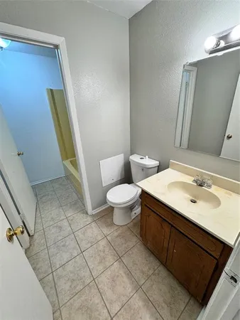 a bathroom with a sink a toilet a mirror and vanity