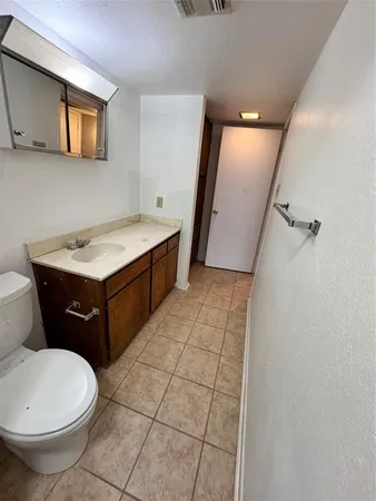 a bathroom with a sink a toilet and mirror