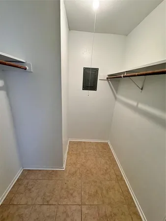 a view of a room with wooden floor and fan