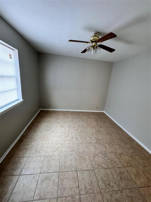 2703 Southside Drive Brownwood, TX 76801 - Photo 10 of 14 an empty room with windows and fan
