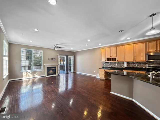 an open kitchen with kitchen island and stainless steel appliances