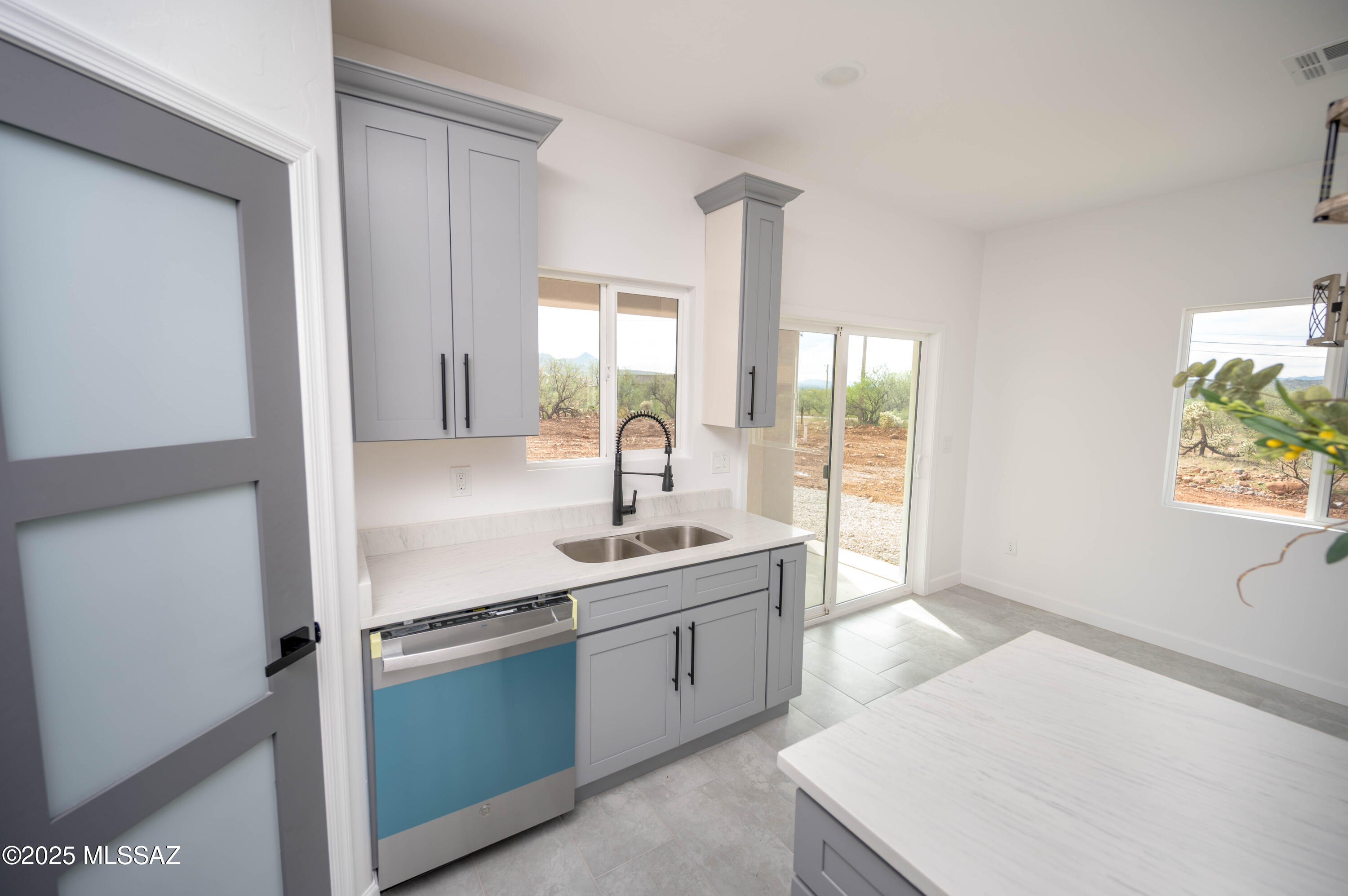 1781 Elder Court Rio Rico, AZ 85648 - Photo 44 of 50 a kitchen with a sink stove and cabinets