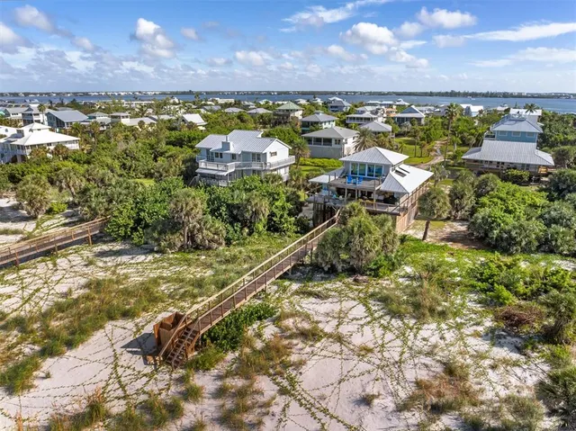 a kitchen with stainless steel appliances kitchen island granite countertop a table and chairs in it