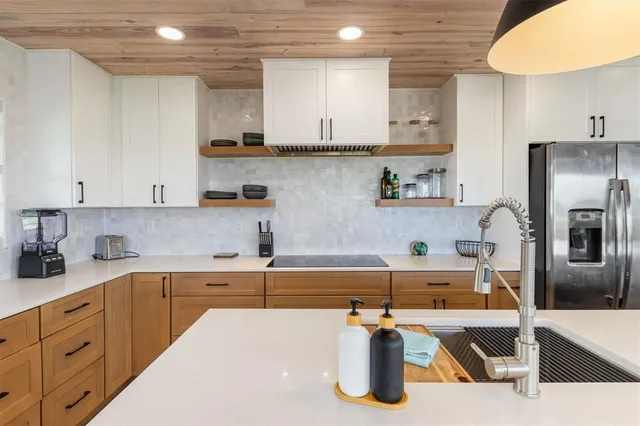 a living room with furniture stairs and a large window