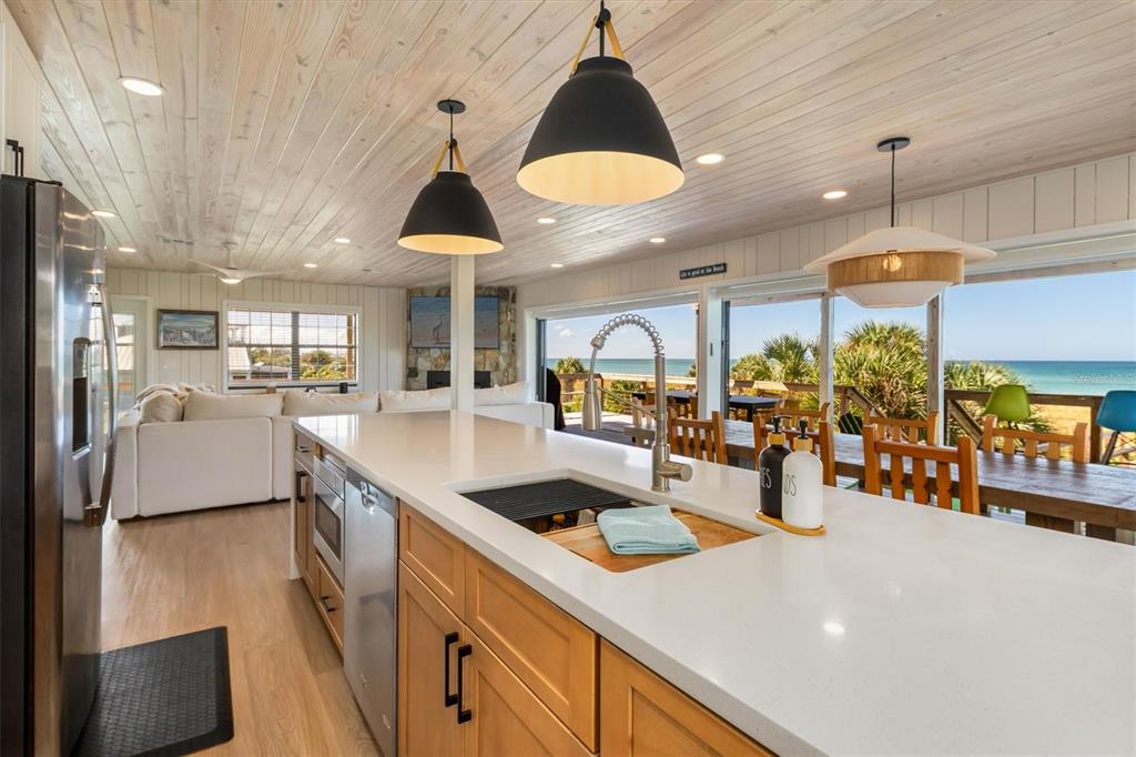 9498 Alborado Road Boca Grande, FL 33921 - Photo 13 of 81 a kitchen with stainless steel appliances granite countertop a sink a stove and a wooden floors