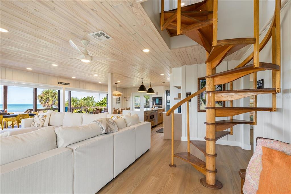 9498 Alborado Road Boca Grande, FL 33921 - Photo 14 of 81 a living room with furniture stairs and a large window