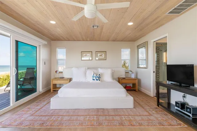 a view of a livingroom with furniture and floor to ceiling window