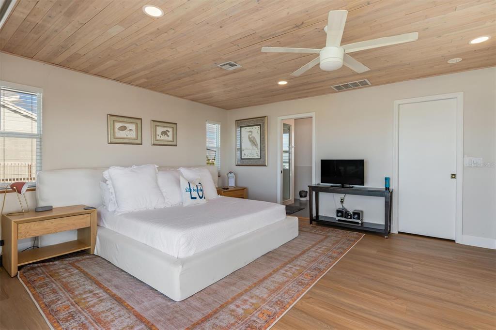 9498 Alborado Road Boca Grande, FL 33921 - Photo 21 of 81 a bedroom with a bed and a flat screen tv