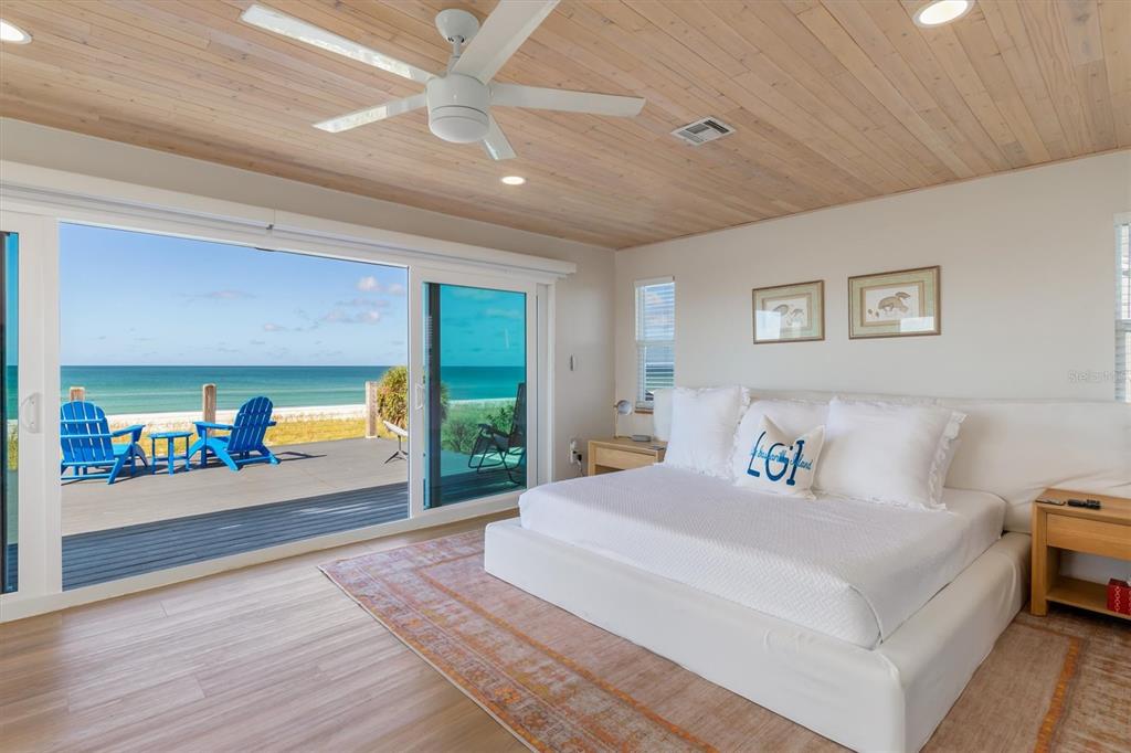 9498 Alborado Road Boca Grande, FL 33921 - Photo 22 of 81 a spacious bedroom with a bed and a large window