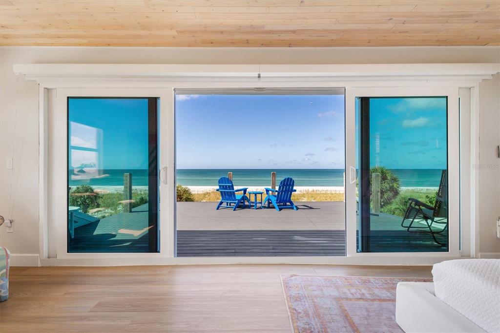 9498 Alborado Road Boca Grande, FL 33921 - Photo 24 of 81 a view of a livingroom with furniture and floor to ceiling window