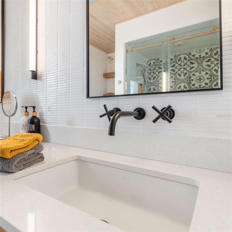 9498 Alborado Road Boca Grande, FL 33921 - Photo 29 of 81 a bathroom with a tub sink and mirror