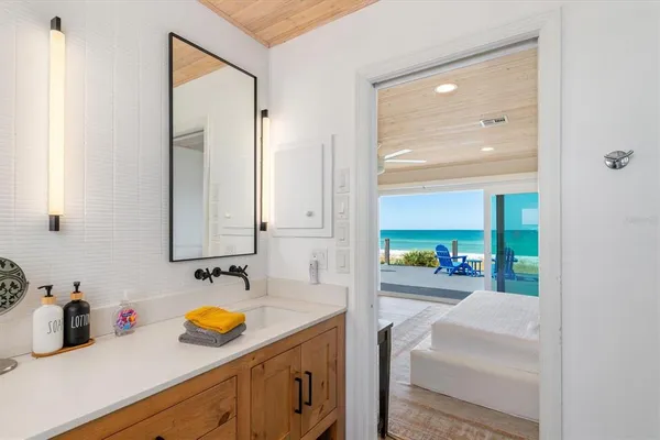 a spacious bathroom with a granite countertop double vanity sink a mirror and a toilet