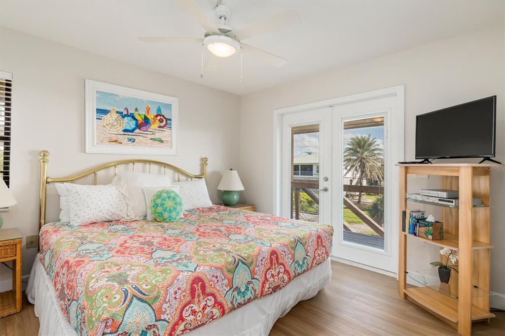 9498 Alborado Road Boca Grande, FL 33921 - Photo 32 of 81 a bedroom with a bed and a flat screen tv