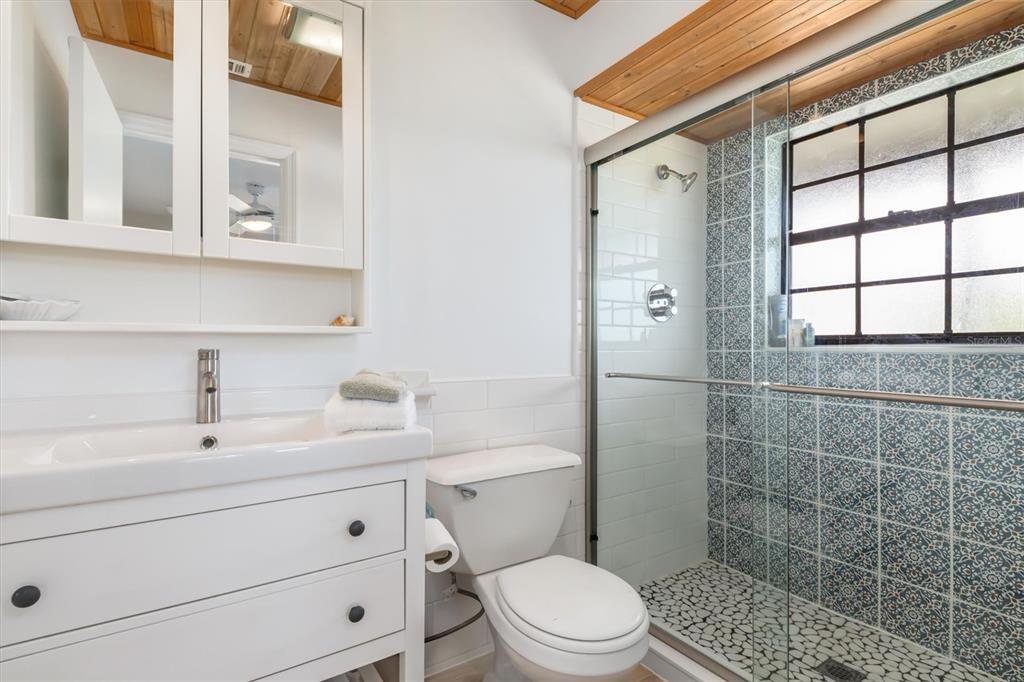 9498 Alborado Road Boca Grande, FL 33921 - Photo 36 of 81 a bathroom with a sink a toilet and shower