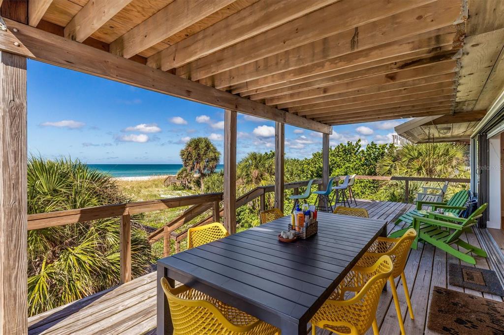 9498 Alborado Road Boca Grande, FL 33921 - Photo 46 of 81 a view of a porch with furniture and wooden floor