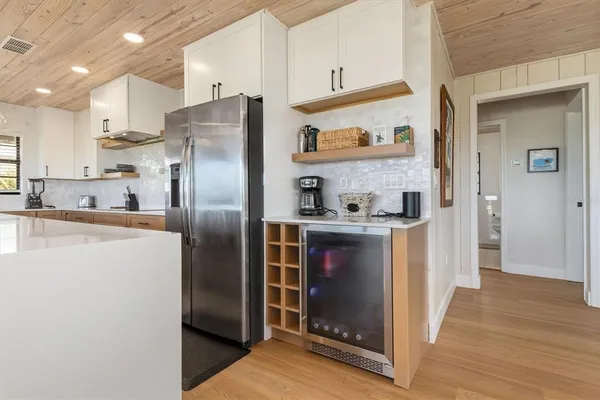 a kitchen with stainless steel appliances a sink a stove and cabinets