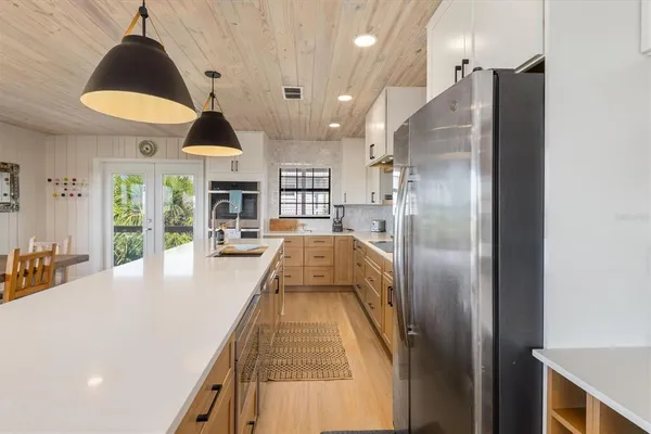 a kitchen with a table chairs and a stove