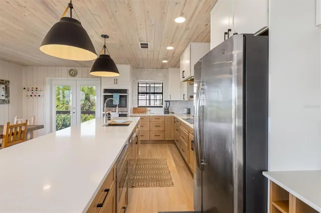 a kitchen with a table chairs and a stove