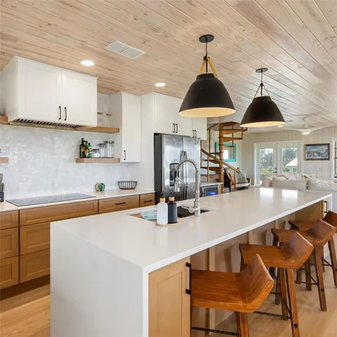 a kitchen with stainless steel appliances granite countertop a sink and cabinets