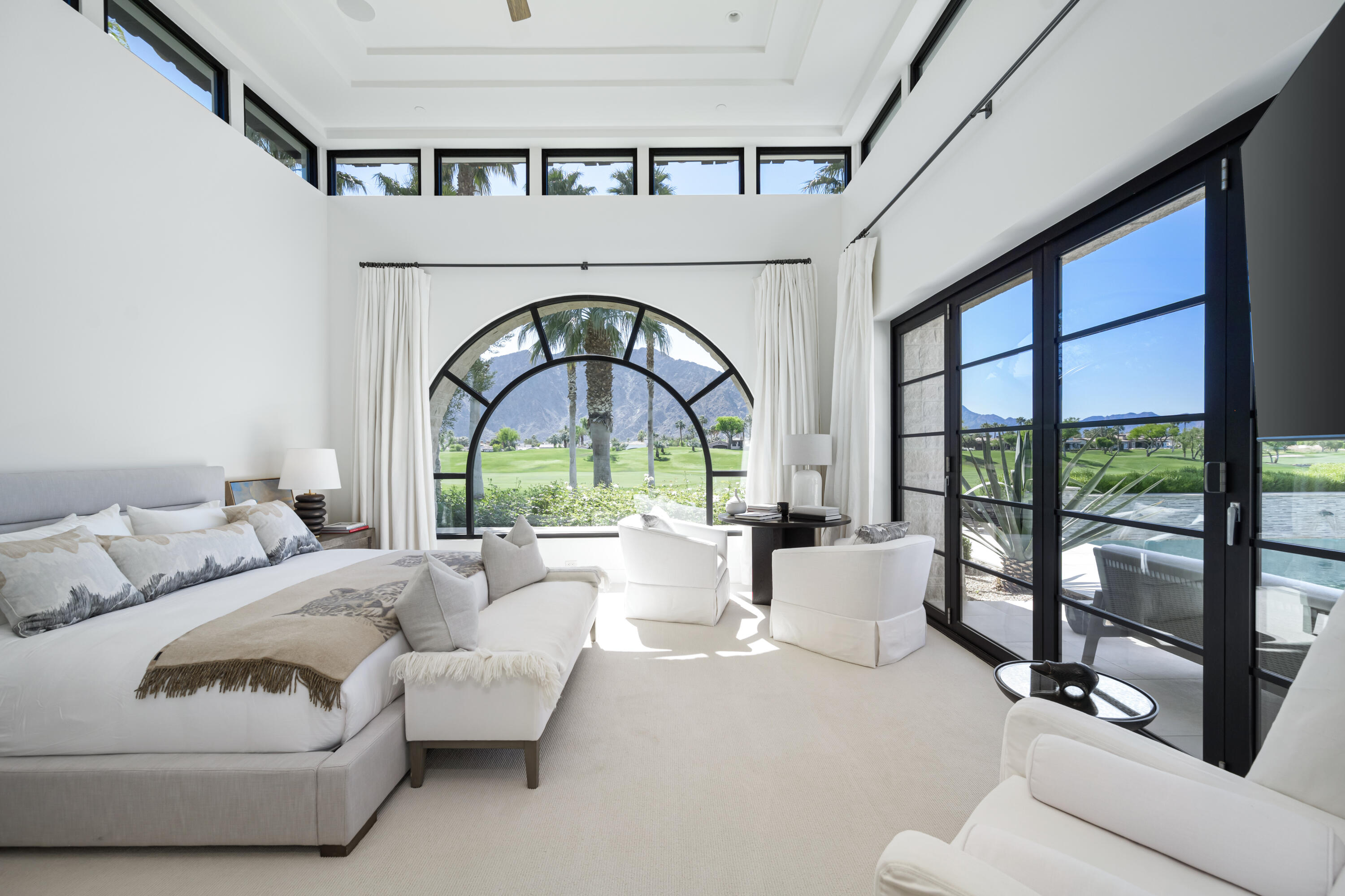 53615 Via Strada La Quinta, CA 92253 - Photo 19 of 52 a living room with furniture a fireplace and a large window