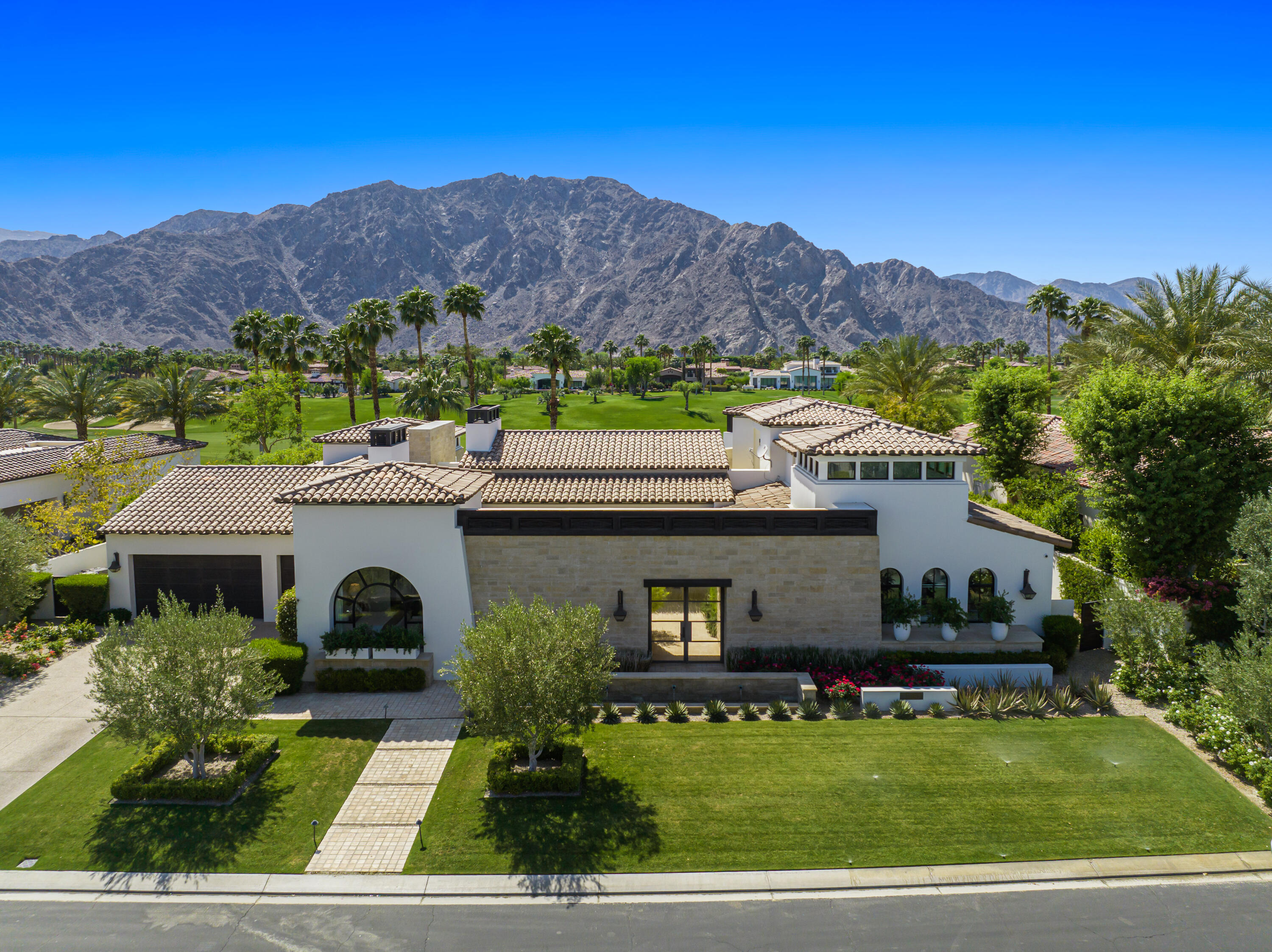 53615 Via Strada La Quinta, CA 92253 - Photo 4 of 52 a front view of house with yard and mountain