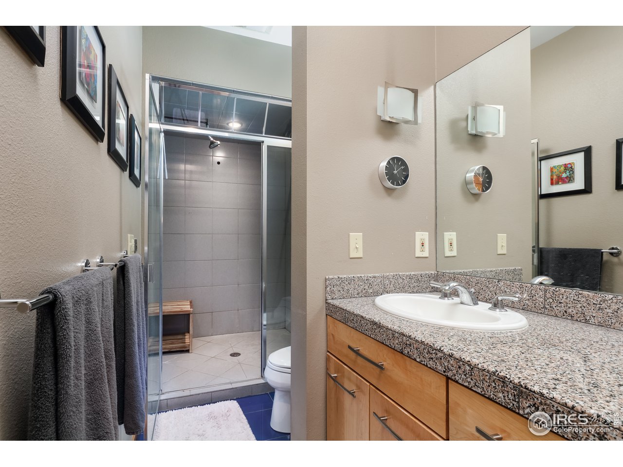 116 Ramona Road Golden, CO 80403 - Photo 27 of 40 a bathroom with a granite countertop sink a mirror a shower and a toilet