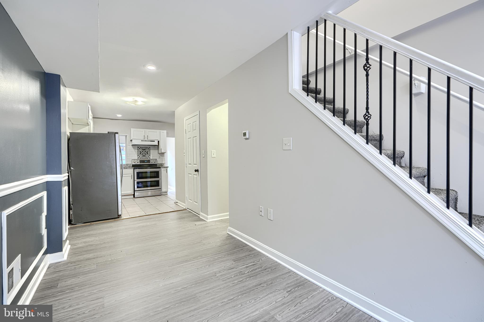 1127 Sargeant Street Baltimore, MD 21223 - Photo 9 of 34 a view of a hallway with wooden floor