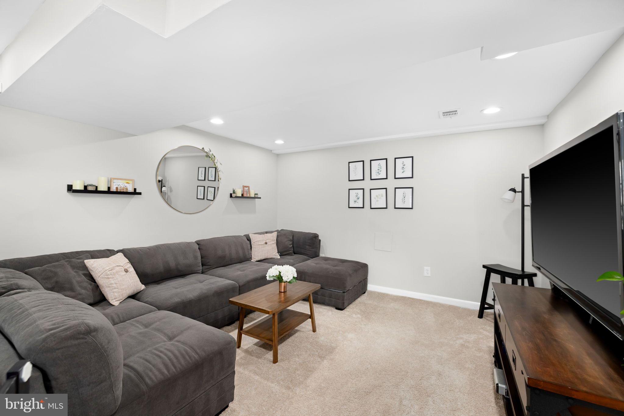 6502 Haystack Road Alexandria, VA 22310 - Photo 19 of 30 a living room with furniture and a flat screen tv