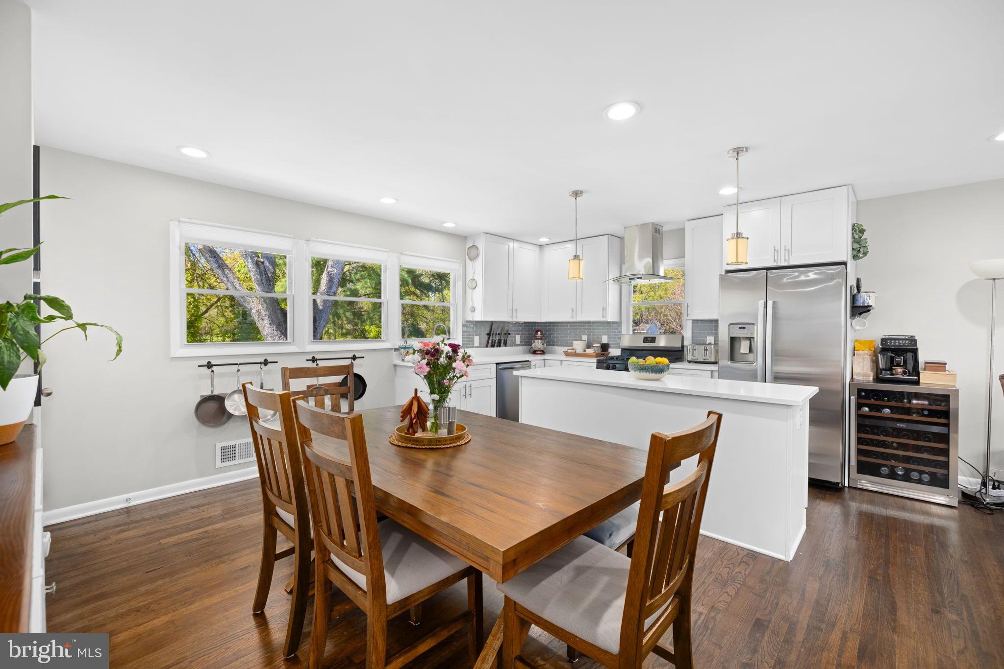 6502 Haystack Road Alexandria, VA 22310 - Photo 7 of 30 a kitchen with kitchen island a dining table and chairs
