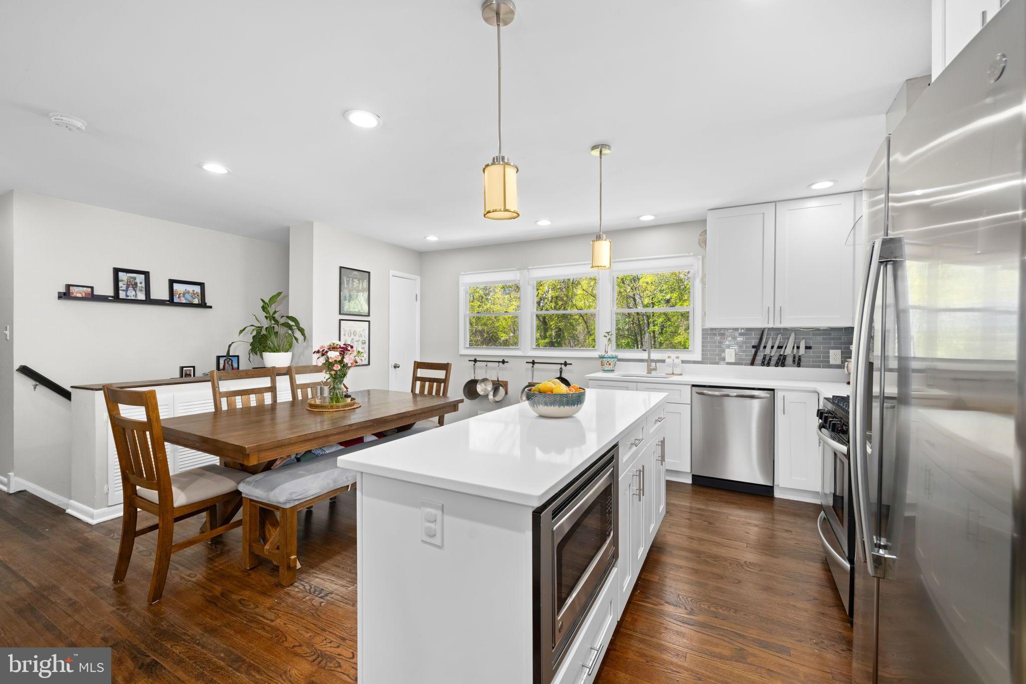 6502 Haystack Road Alexandria, VA 22310 - Photo 9 of 30 a kitchen with a stove a refrigerator and a dining table