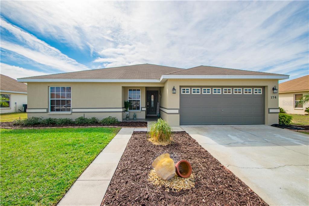 174 Cloverdale Road Winter Haven, FL 33884 - Photo 1 of 1 a front view of a house with garden