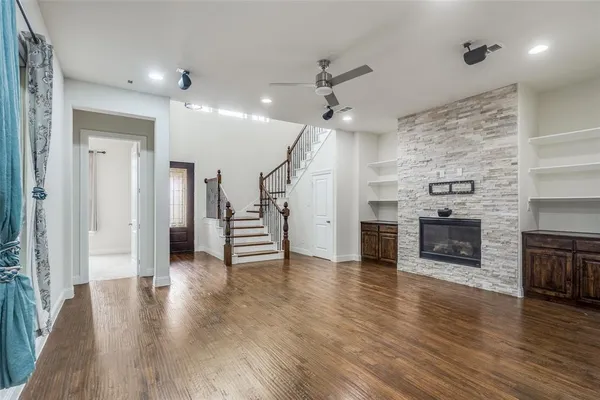 a view of a livingroom with a fireplace and wooden floor
