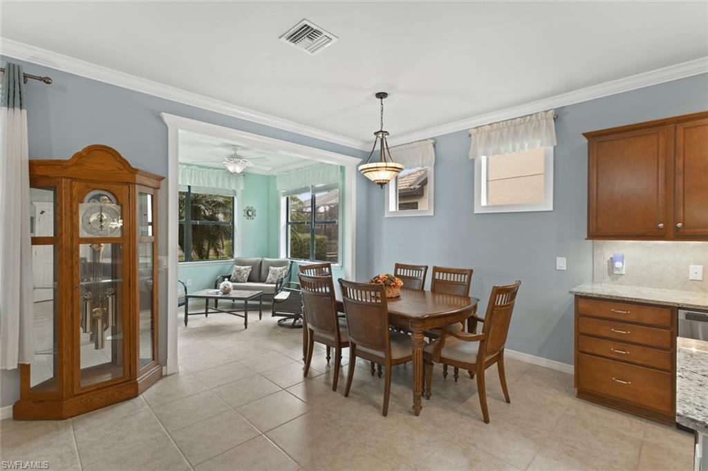 6085 Triumph Lane Ave Maria, FL 34142 - Photo 12 of 42 a view of a a dining room with furniture window and wooden floor